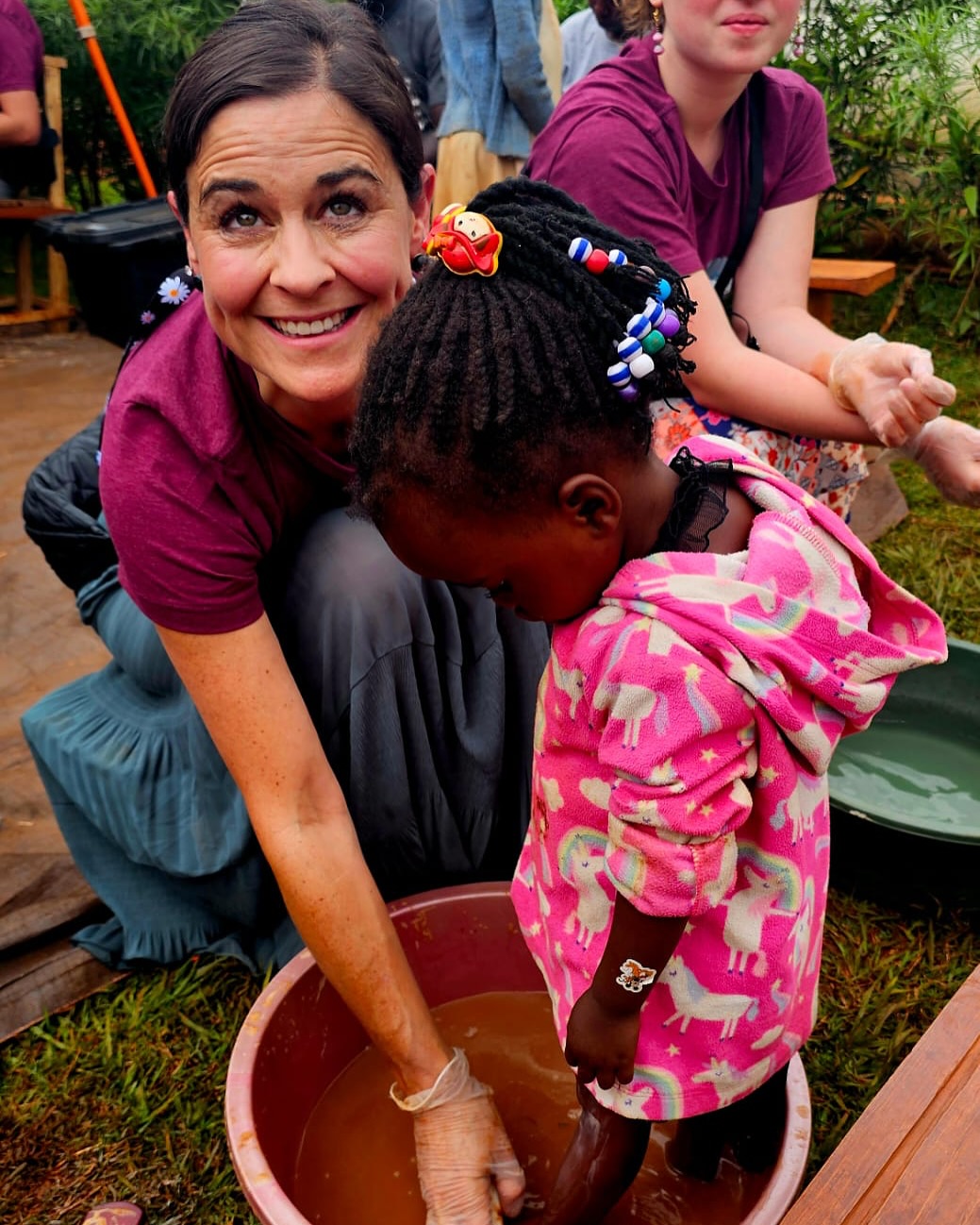 Melissa washing a child's feet at Sole Hope